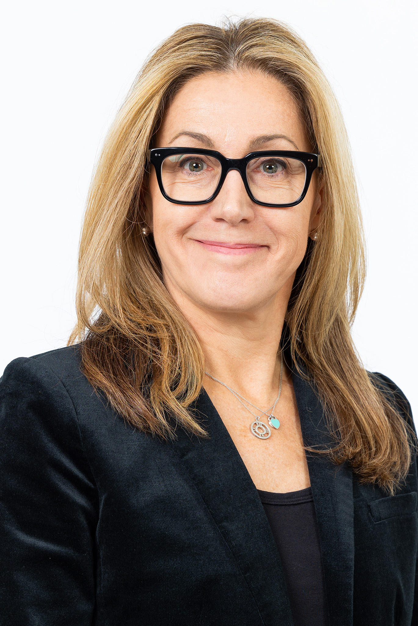 Portrait of Maria S. Wolfe, MD, MS, MOT, SSW Director of Online Education Design, wearing black glasses and a dark blazer against a light background.